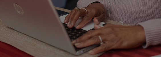 Picture of hands on computer.